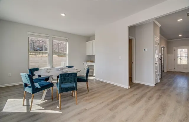 a dining room with furniture and wooden floor