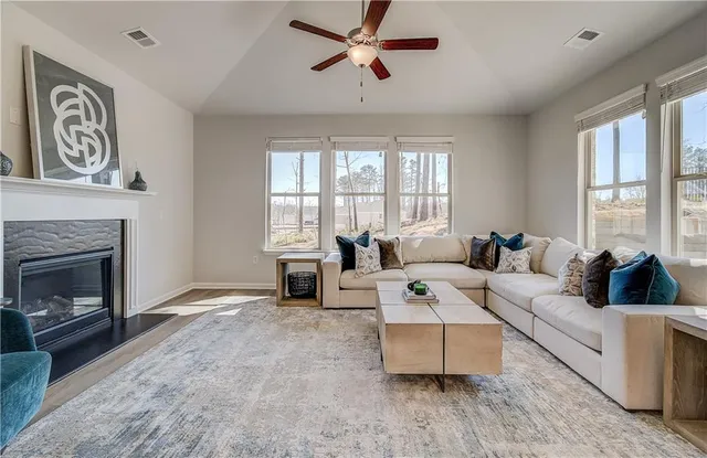a living room with furniture and a fireplace