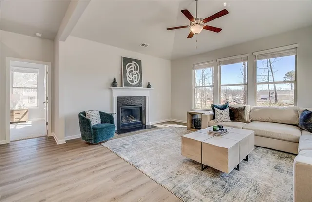 a living room with furniture and a fireplace