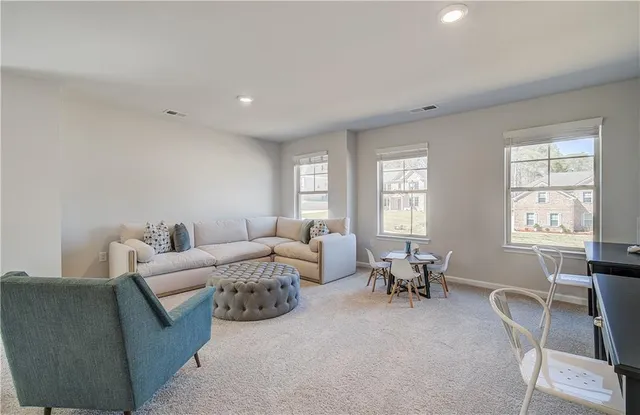 a living room with furniture and windows