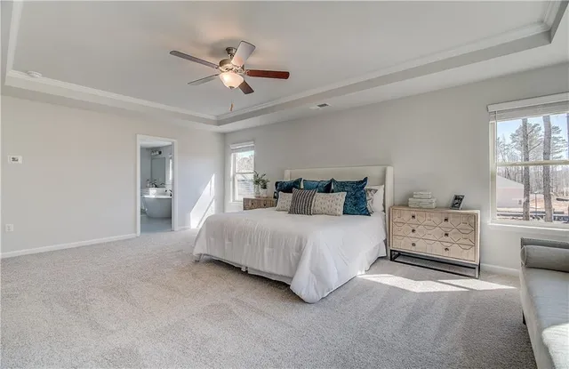a bedroom with a bed a dresser and flowerpot