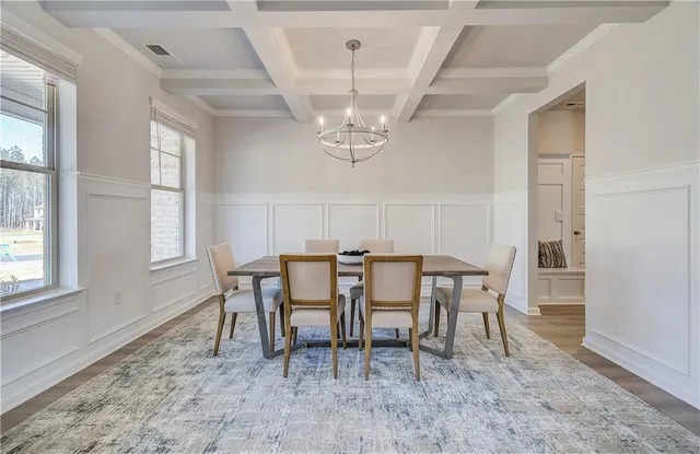 a view of a dining room with furniture and chandelier