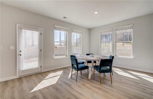 a view of a dining room with furniture and wooden floor