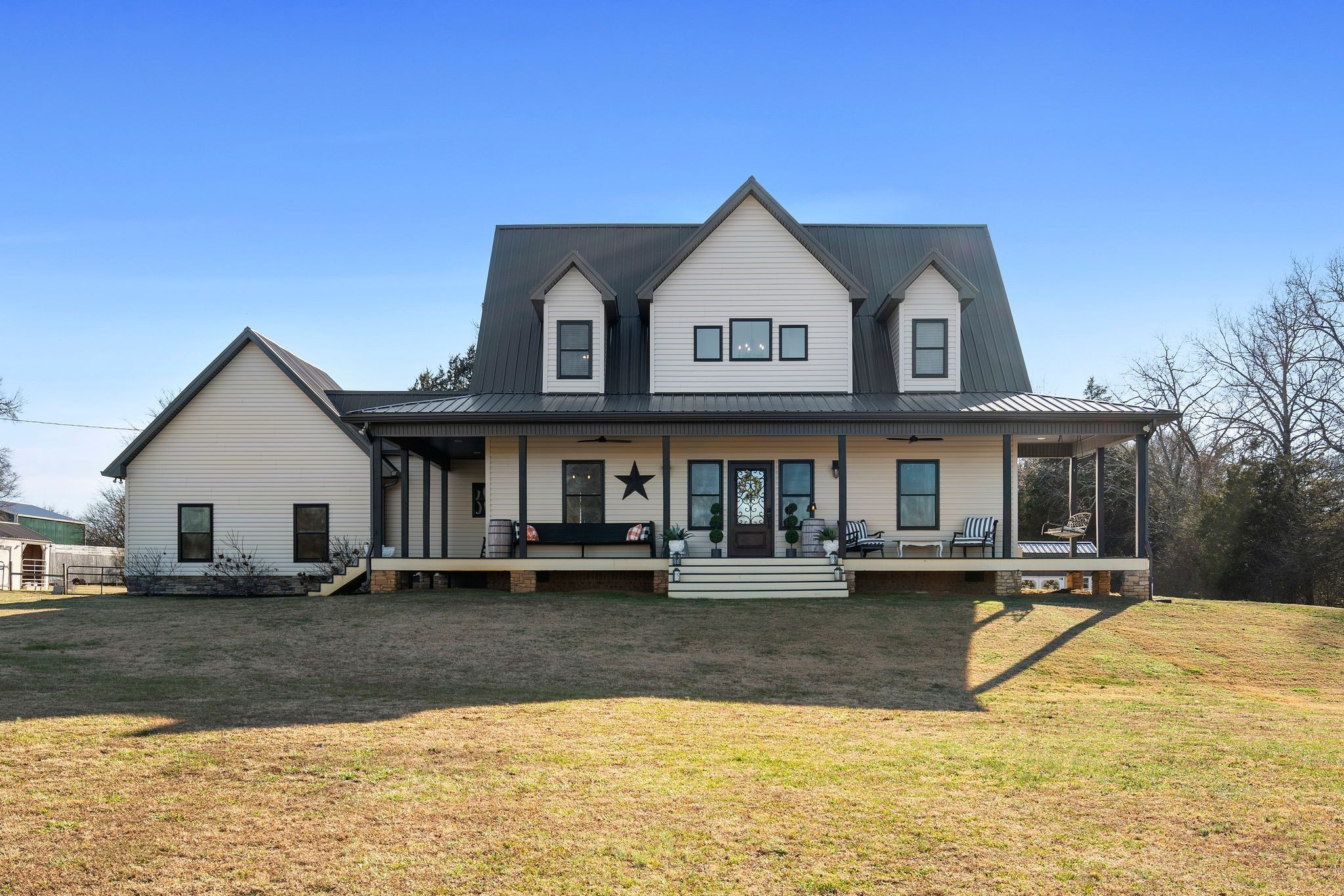 a view of the house with swimming pool and sitting area