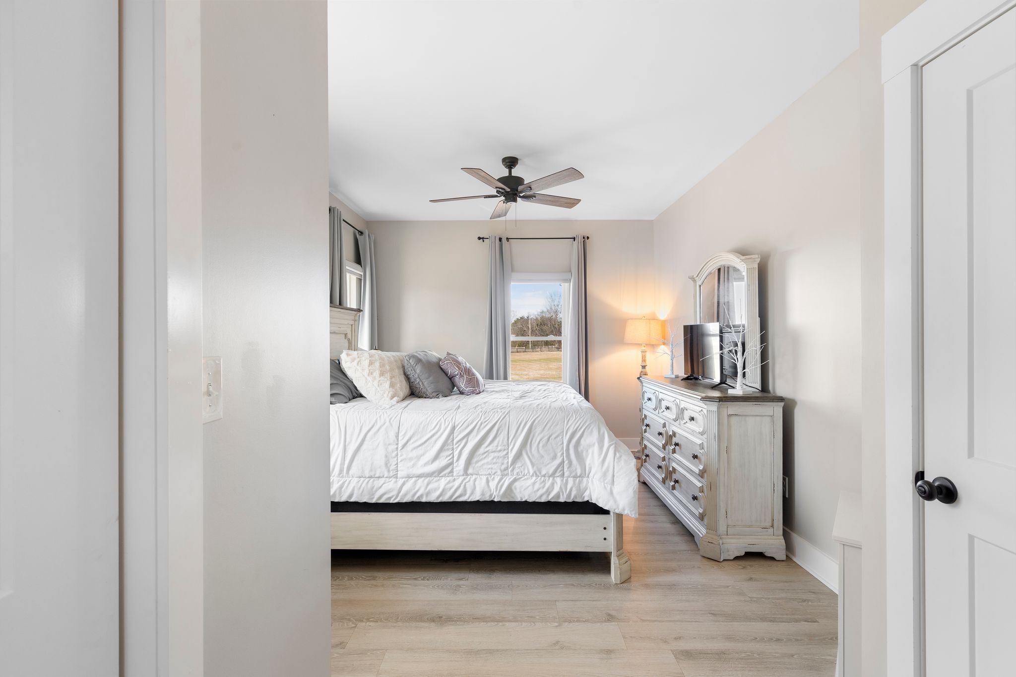 5650 Sledge Road Christiana, TN 37037 - Photo 22 of 50 a bedroom with a bed and a chandelier