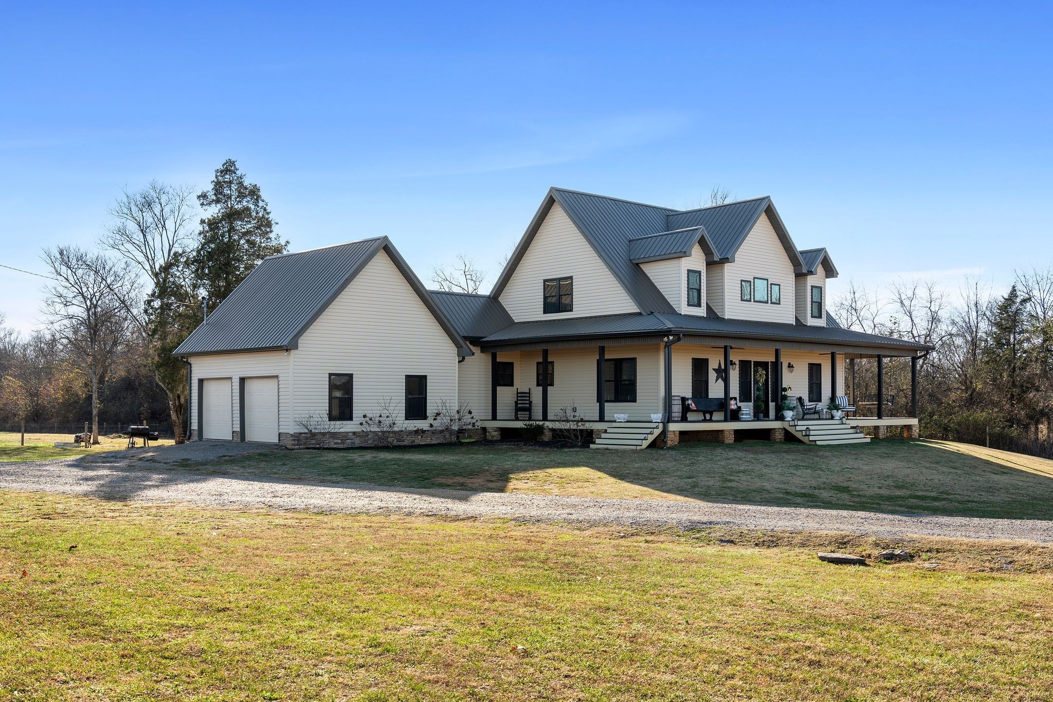 5650 Sledge Road Christiana, TN 37037 - Photo 3 of 50 a view of a white house with a large pool with lawn chairs under an umbrella