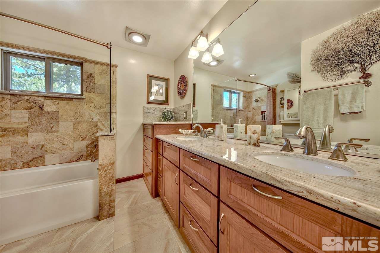 450 Mcfaul Way Zephyr Cove, NV 89448 - Photo 13 of 20 a spacious bathroom with a granite countertop sink mirror and bathtub