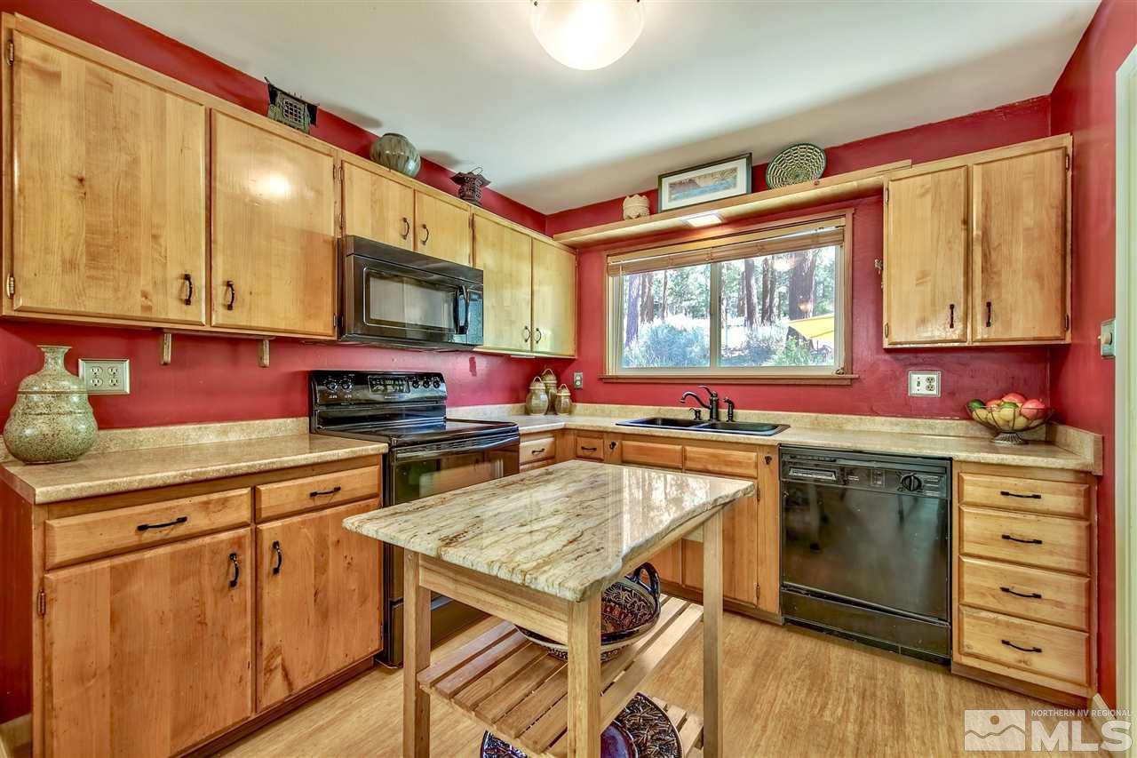 450 Mcfaul Way Zephyr Cove, NV 89448 - Photo 6 of 20 a kitchen with stainless steel appliances granite countertop a stove a sink and a microwave