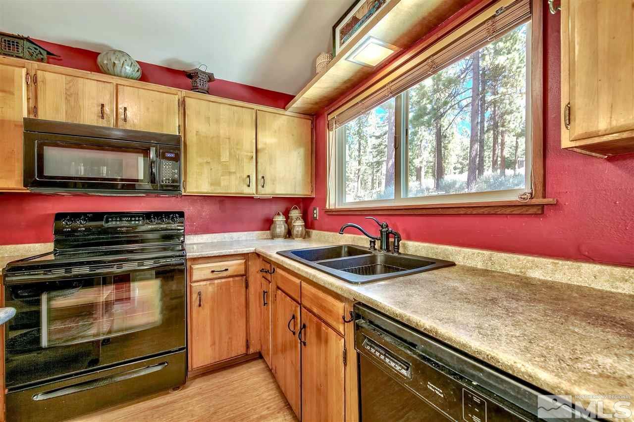 450 Mcfaul Way Zephyr Cove, NV 89448 - Photo 7 of 20 a kitchen with stainless steel appliances granite countertop a stove and a microwave