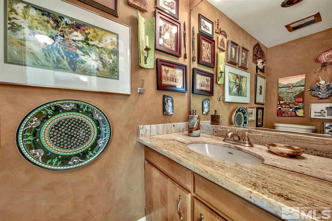 450 Mcfaul Way Zephyr Cove, NV 89448 - Photo 9 of 20 a bathroom with a granite countertop sink and a mirror