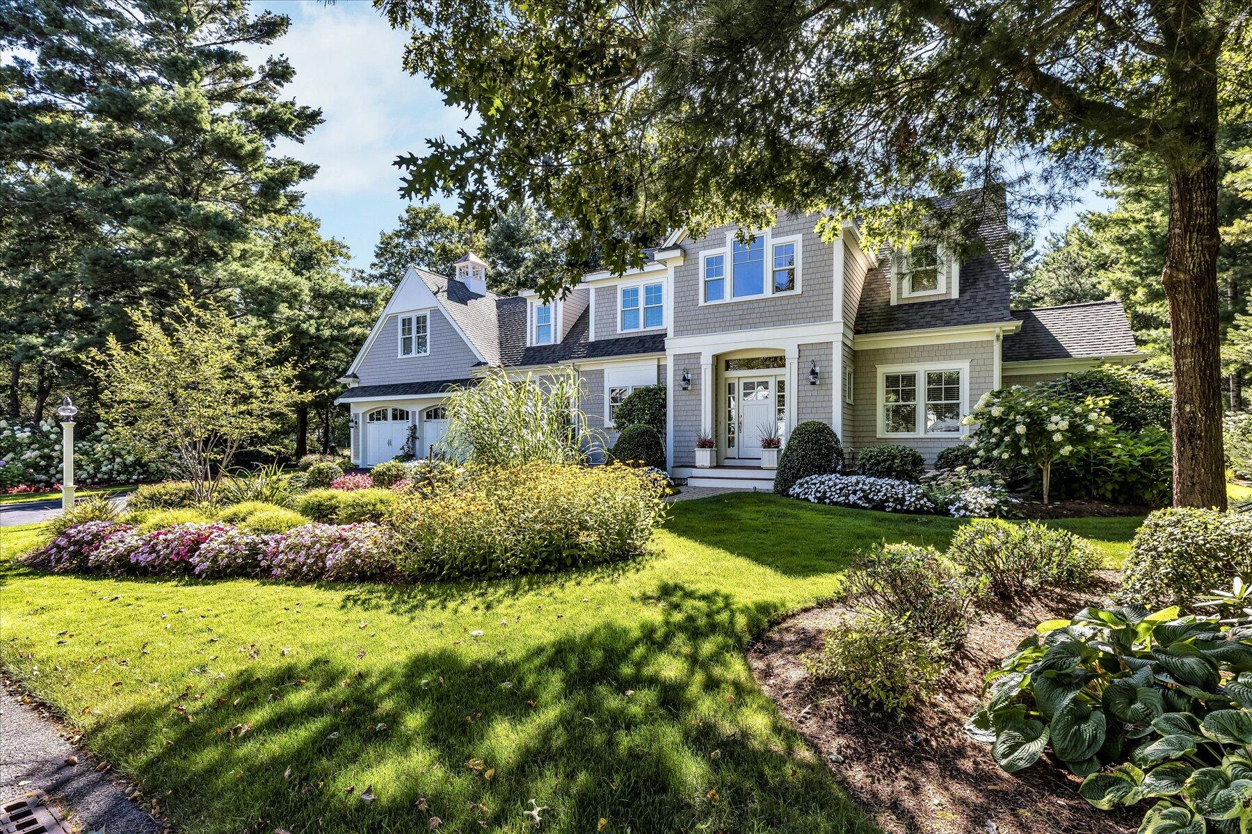 74 The Heights Mashpee, MA 02649 - Photo 2 of 34 a front view of a house with a garden