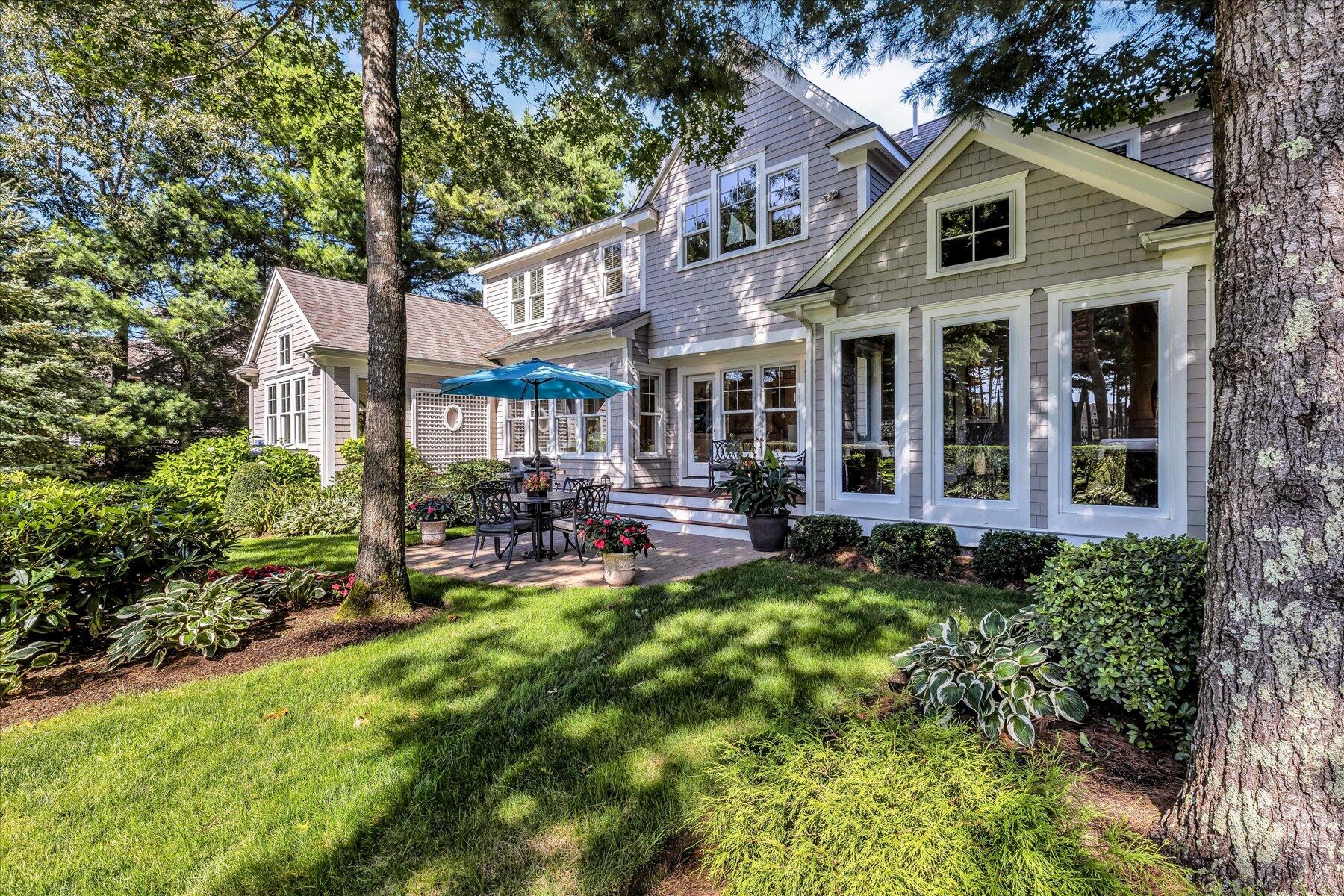 74 The Heights Mashpee, MA 02649 - Photo 3 of 34 a front view of a house with swimming pool and porch