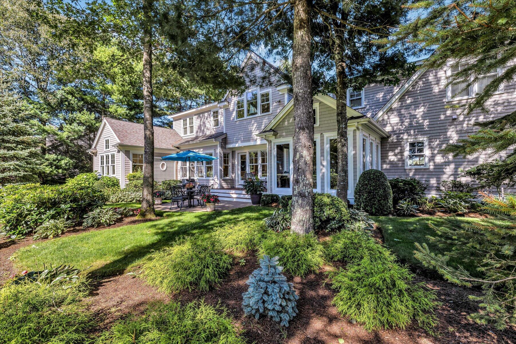 74 The Heights Mashpee, MA 02649 - Photo 6 of 34 a front view of a residential houses with yard and green space