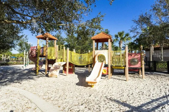 a sitting area with furniture and paintings on the wall