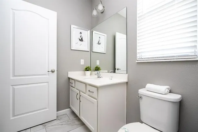 a living room with lots of furniture and view of kitchen