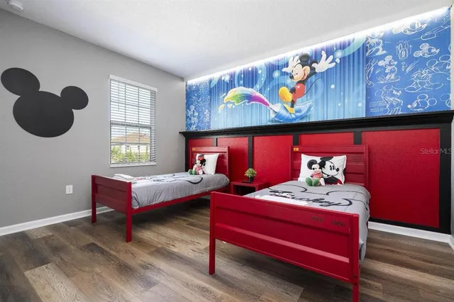 a dining room with wooden floor a glass table and chairs