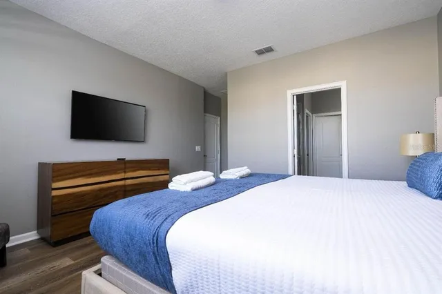 a bedroom with a bed and a flat screen tv