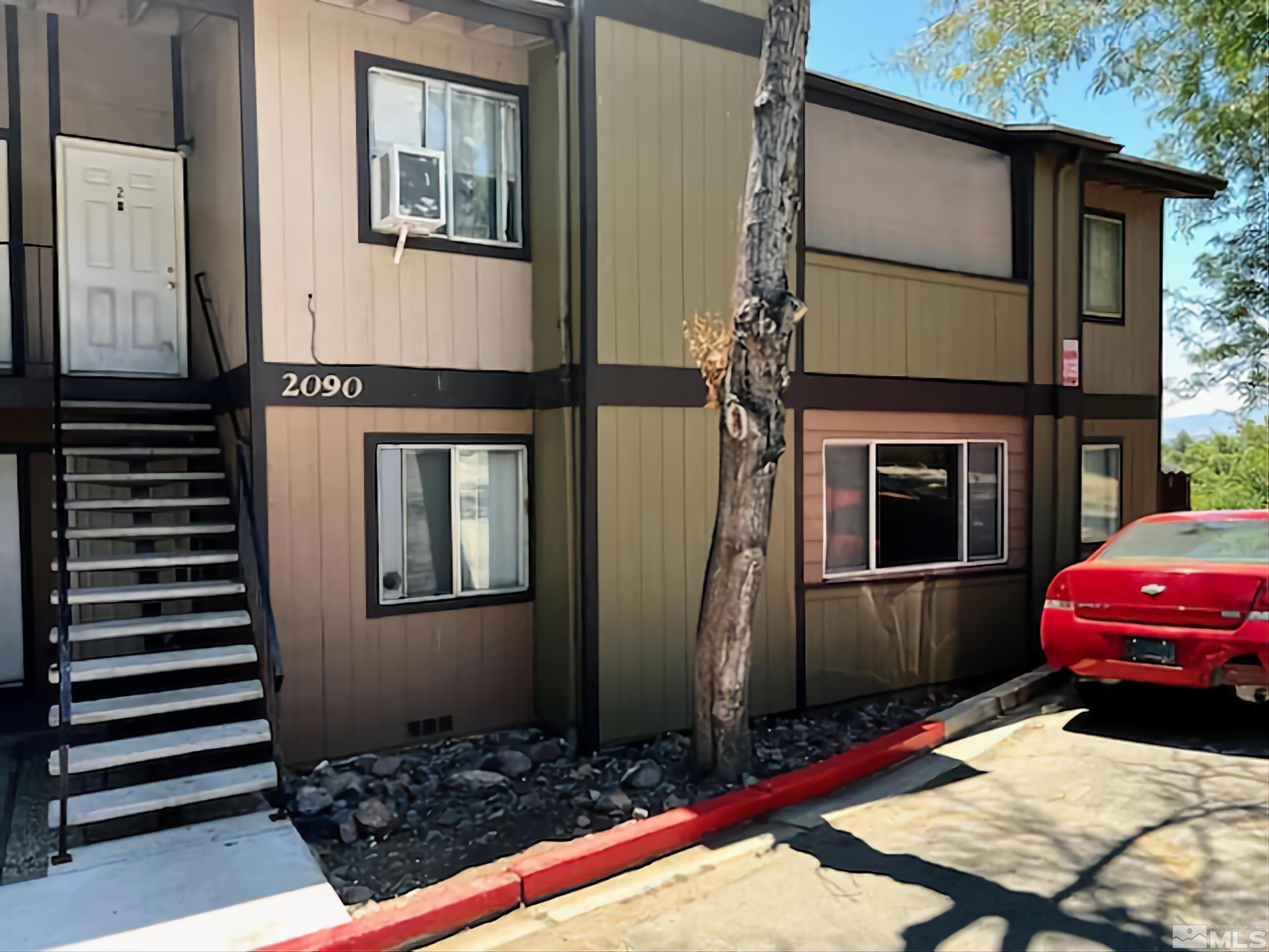 2090 Highview Court, Unit 1 Reno, NV 89512 - Photo 1 of 18 a front view of a house with a garden