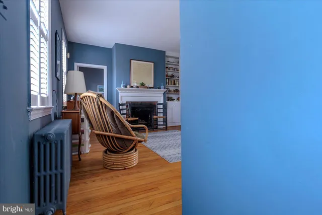 a view of a hallway with wooden floor and stairs