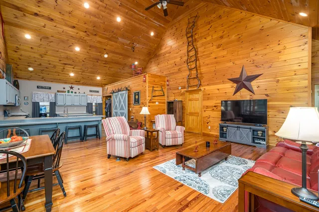 a kitchen with stainless steel appliances granite countertop a table chairs sink and cabinets