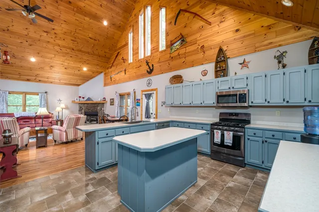 a kitchen with a sink appliances and cabinets