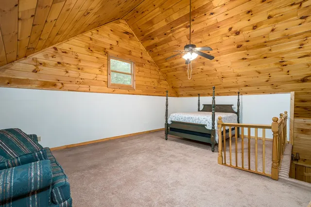 a view of a kitchen with a stove cabinets a ceiling fan and wooden floor