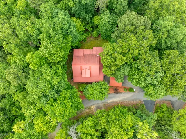 an aerial view of a house with a yard basket ball court and outdoor seating