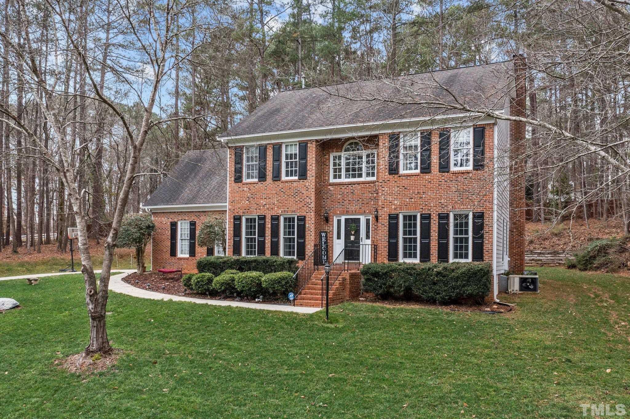 6201 Trevor Court Raleigh, NC 27613 - Photo 4 of 19 a front view of a house with a yard and green space