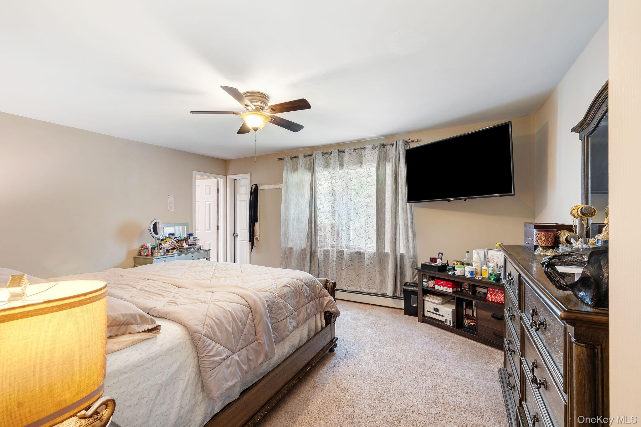 6 Farmstead Road New Windsor, NY 12553 - Photo 17 of 32 Bedroom with light colored carpet, a baseboard heating unit, and ceiling fan