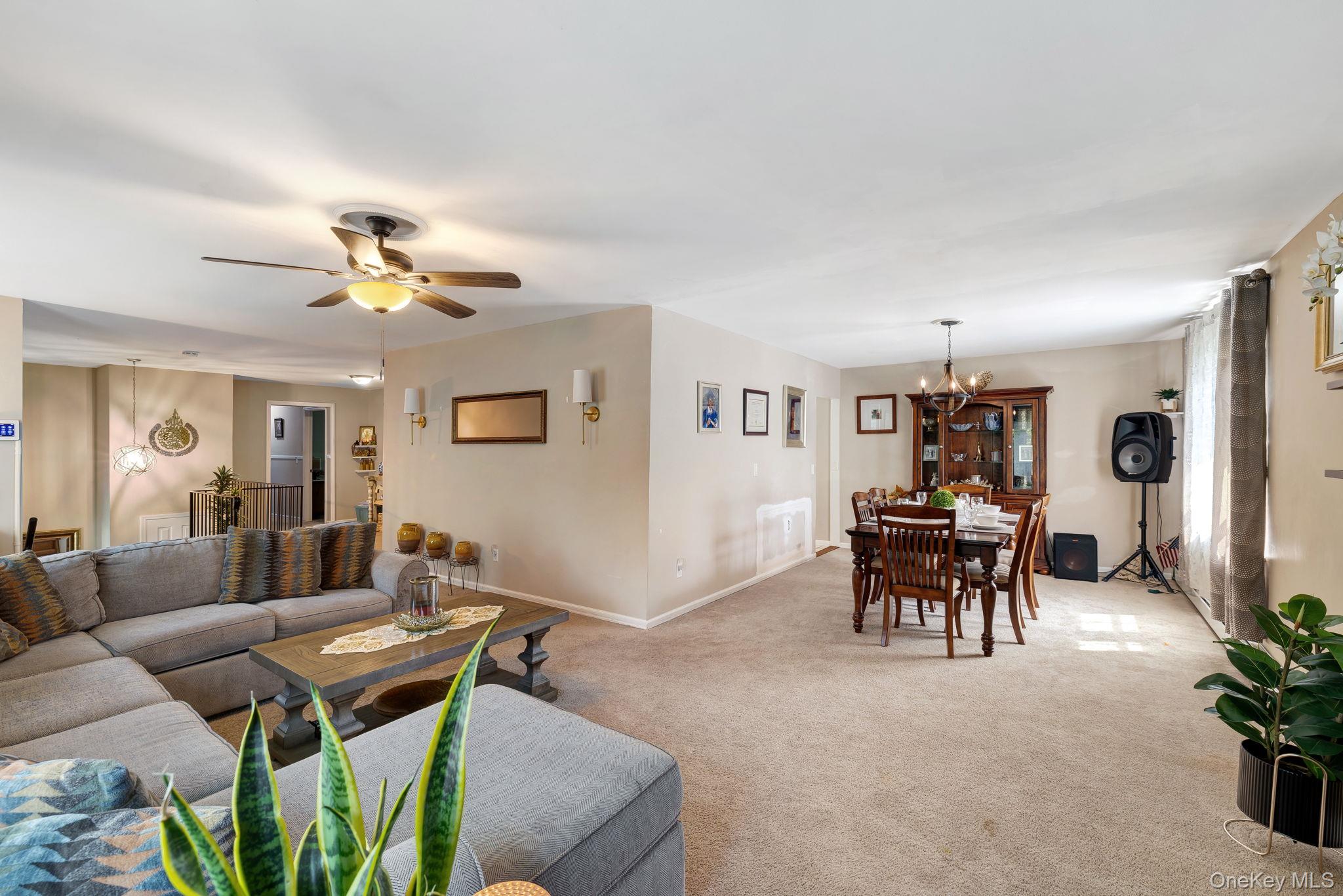 6 Farmstead Road New Windsor, NY 12553 - Photo 8 of 32 Carpeted living area with a chandelier and ceiling fan