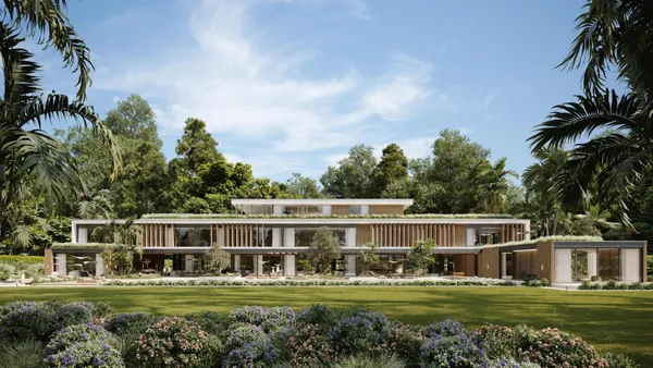 a front view of a house with a garden and trees