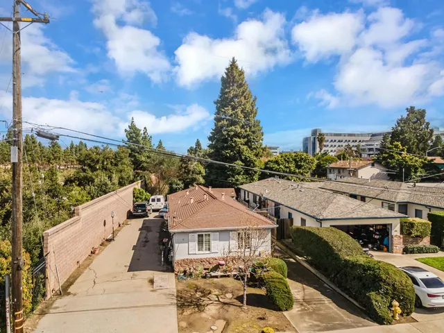 an aerial view of a house with a yard