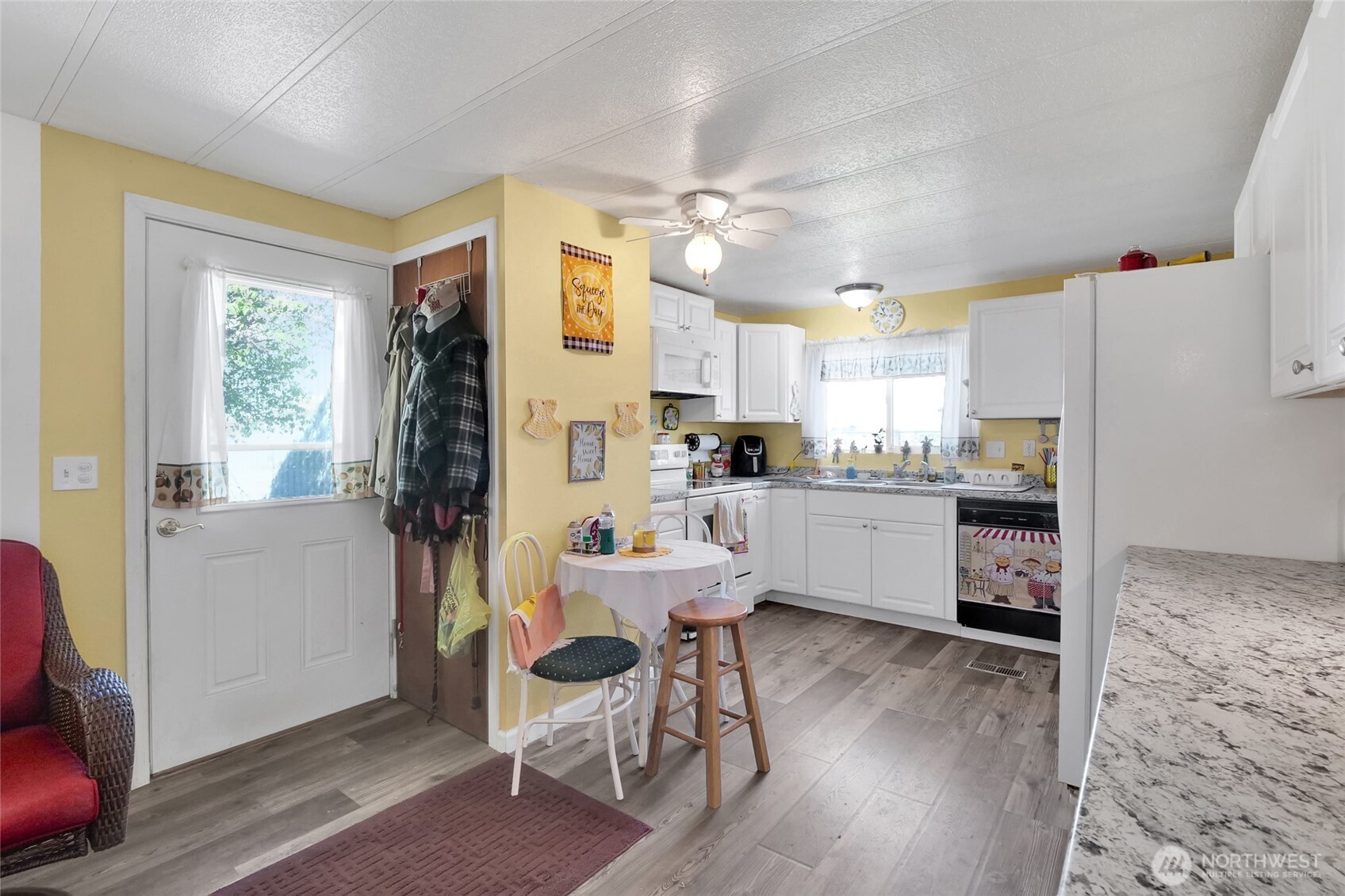 9630 Rd H.8 Northeast Moses Lake, WA 98837 - Photo 13 of 39 a kitchen with microwave a refrigerator and wooden floor