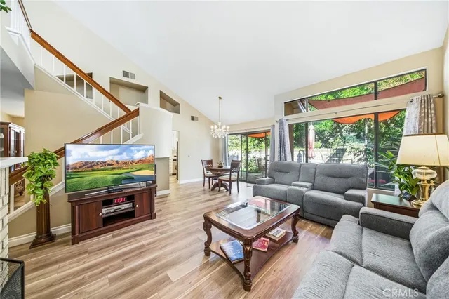 a view of a hallway with wooden floor and windows