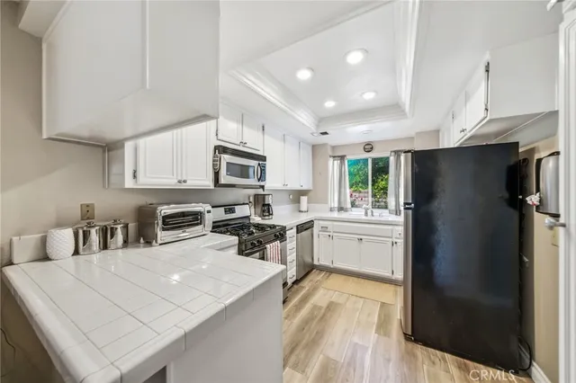 a patio with table and chairs and potted plants