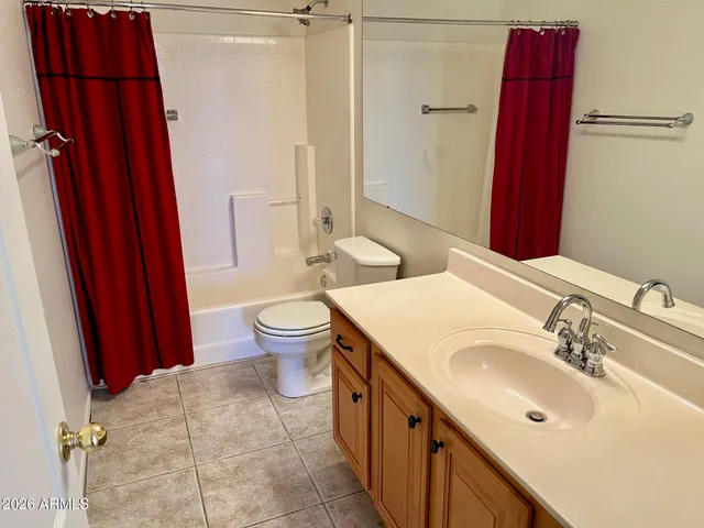 a bathroom with a sink a toilet a mirror and shower