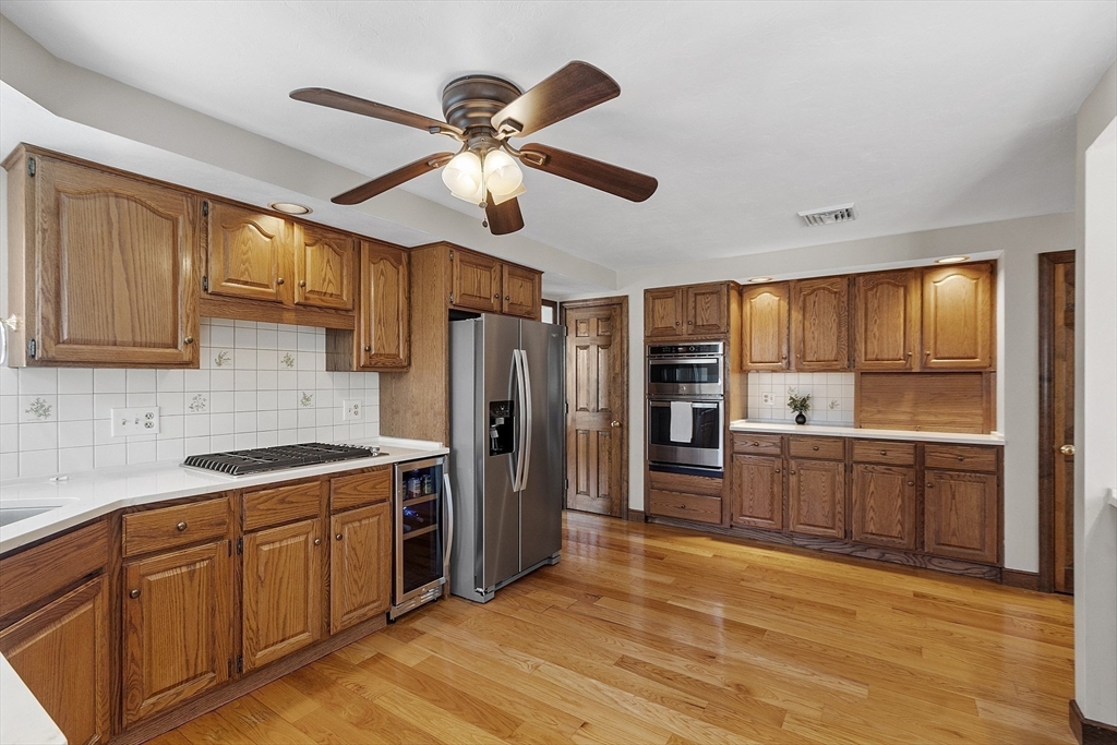 2 Abigail Drive Hudson, MA 01749 - Photo 13 of 42 a kitchen with stainless steel appliances granite countertop a refrigerator a sink dishwasher a stove with wooden cabinets and floor