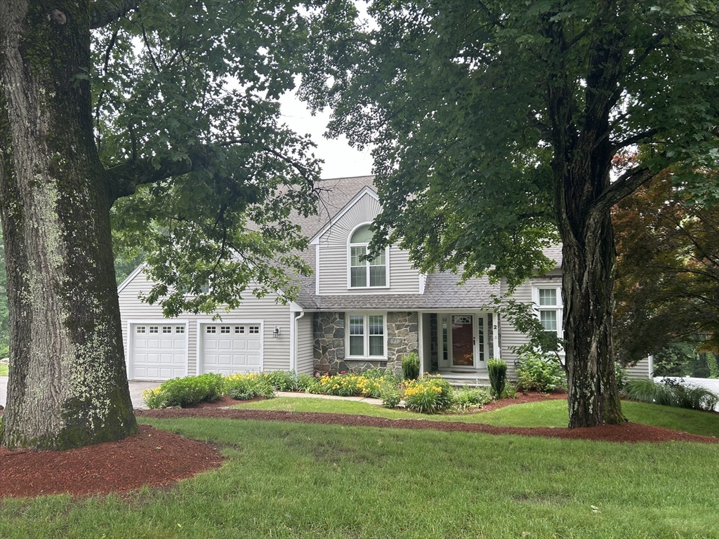 2 Abigail Drive Hudson, MA 01749 - Photo 2 of 42 a front view of a house with garden and trees