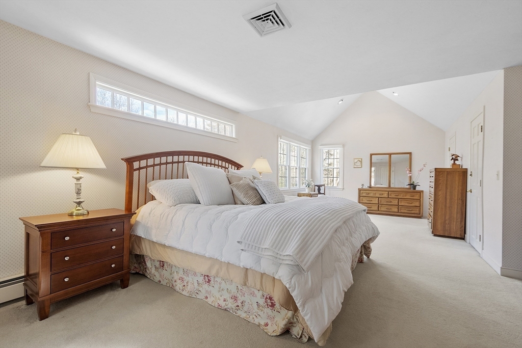 2 Abigail Drive Hudson, MA 01749 - Photo 23 of 42 a spacious bedroom with a bed a lamp and a large window