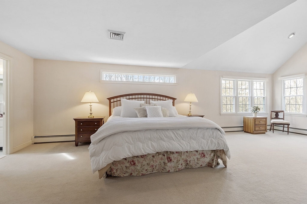 2 Abigail Drive Hudson, MA 01749 - Photo 24 of 42 a spacious bedroom with a bed a couch and large windows