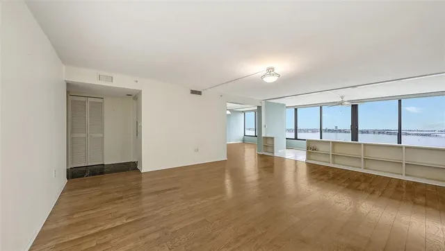 wooden floor in an empty room with a window