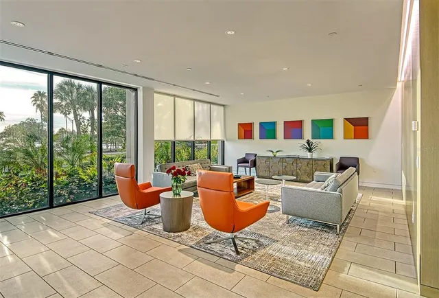 a living room with fireplace furniture and large windows