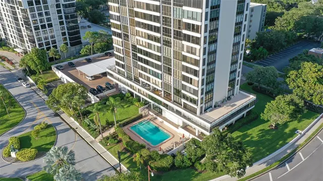an aerial view of a residential apartment building with a yard