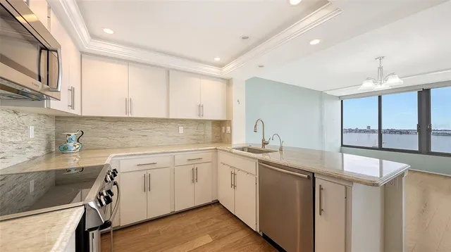 a kitchen with a sink cabinets and window