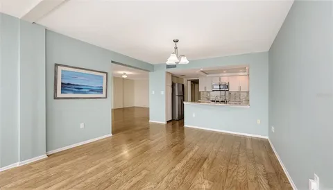 a view of a kitchen with a dishwasher cabinets and wooden floor