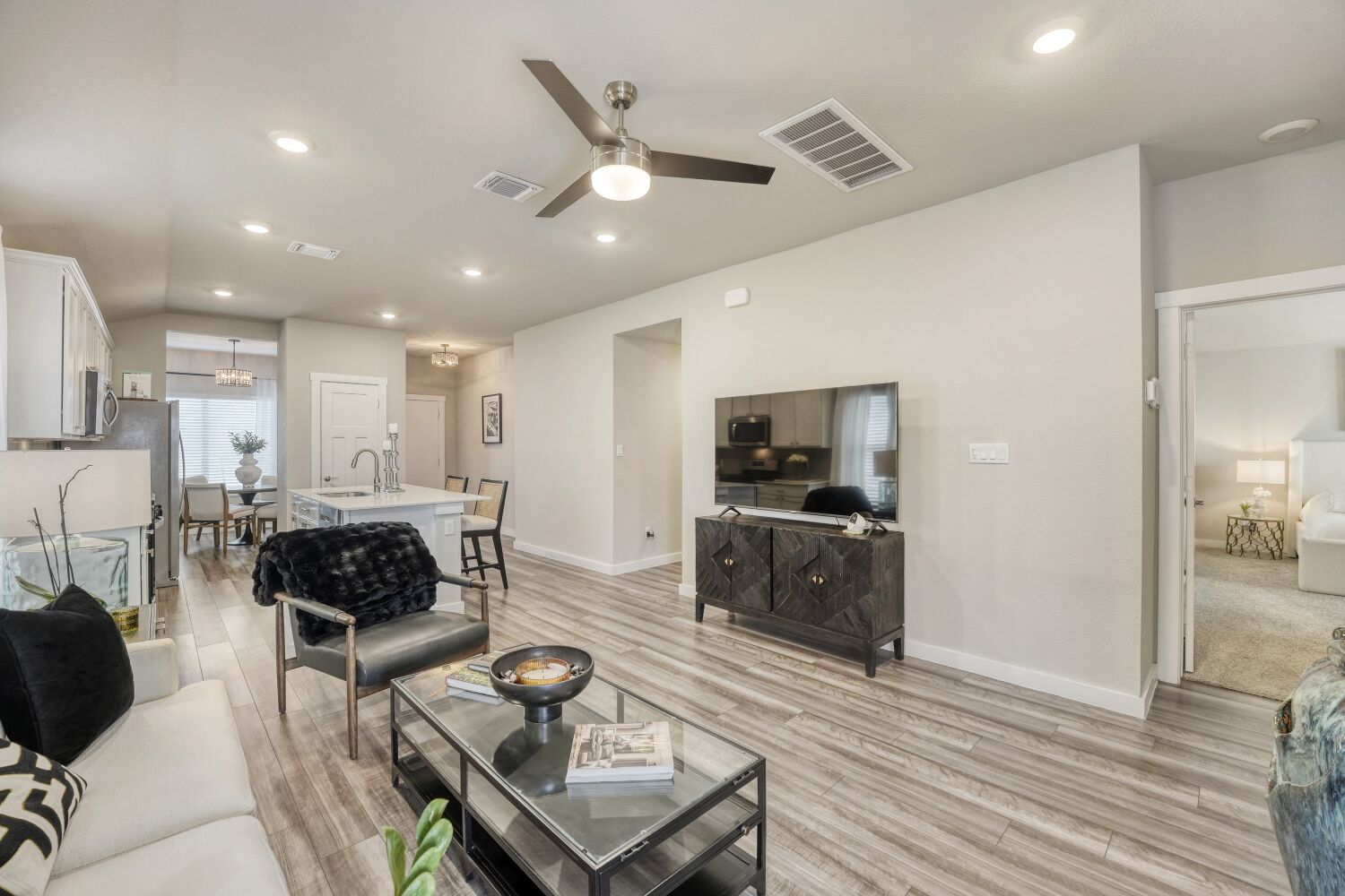 200 Coda Crossing Georgetown, TX 78633 - Photo 6 of 29 a living room with furniture a flat screen tv and kitchen view