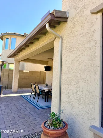 a view of a house with backyard sitting area and garden