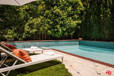 a view of swimming pool with lounge chair