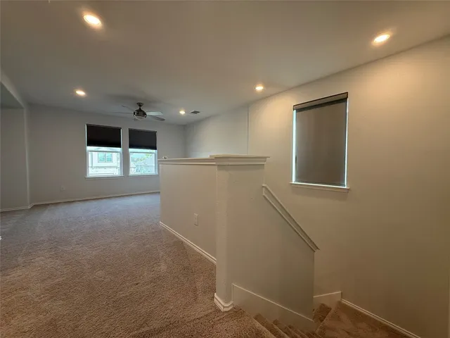 an empty room with a empty space and windows