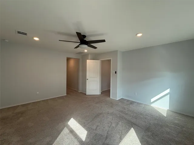 a spacious bathroom with a granite countertop sink a toilet mirror and bathtub
